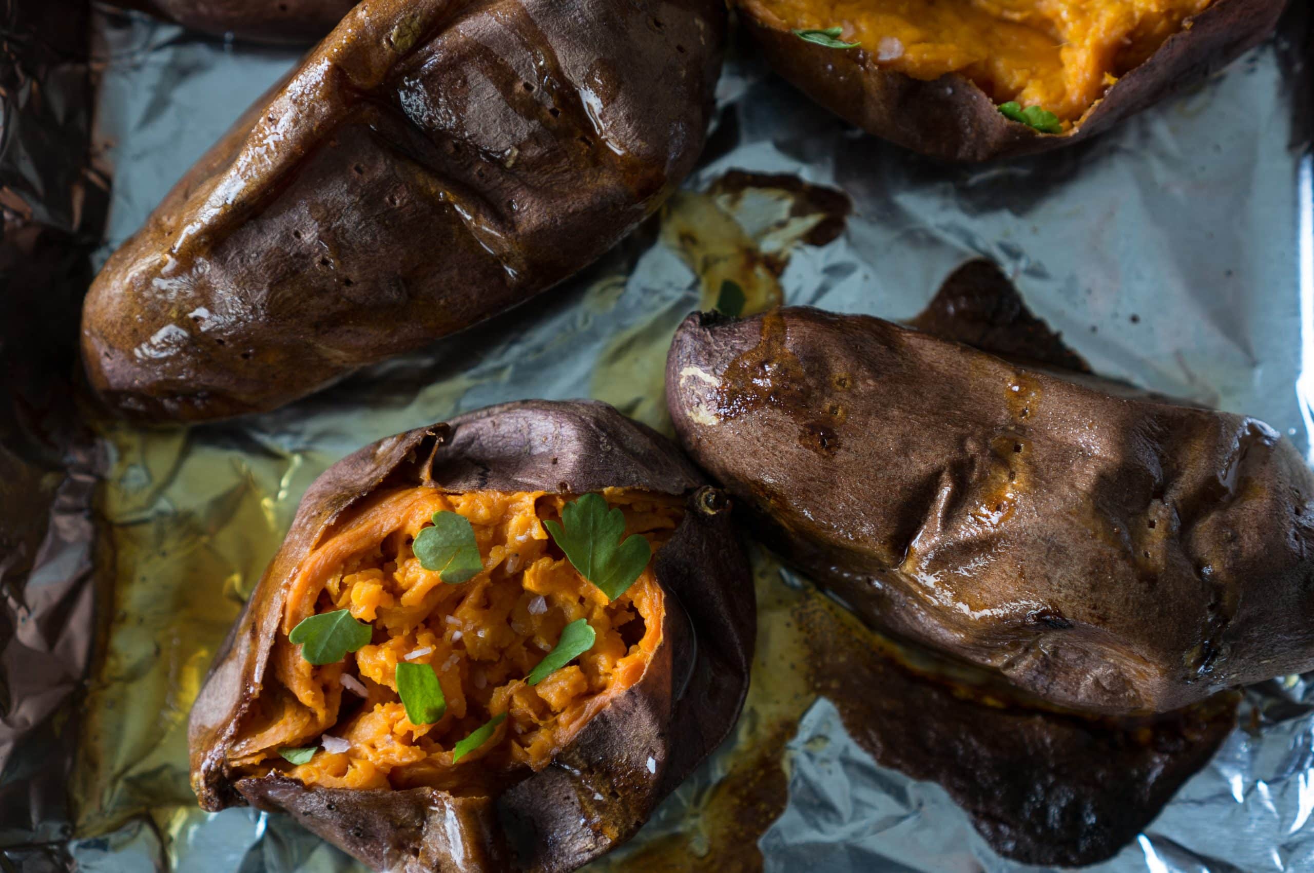 Slow Roasted Sticky Sweet Potatoes - We love this simple, vegan recipe for Slow Roasted Sticky Sweet Potatoes! Just 2 ingredients (olive oil + sweet potatoes) & a hot oven are all you need for perfectly caramelized sweet potatoes every time | freeyourfork.com