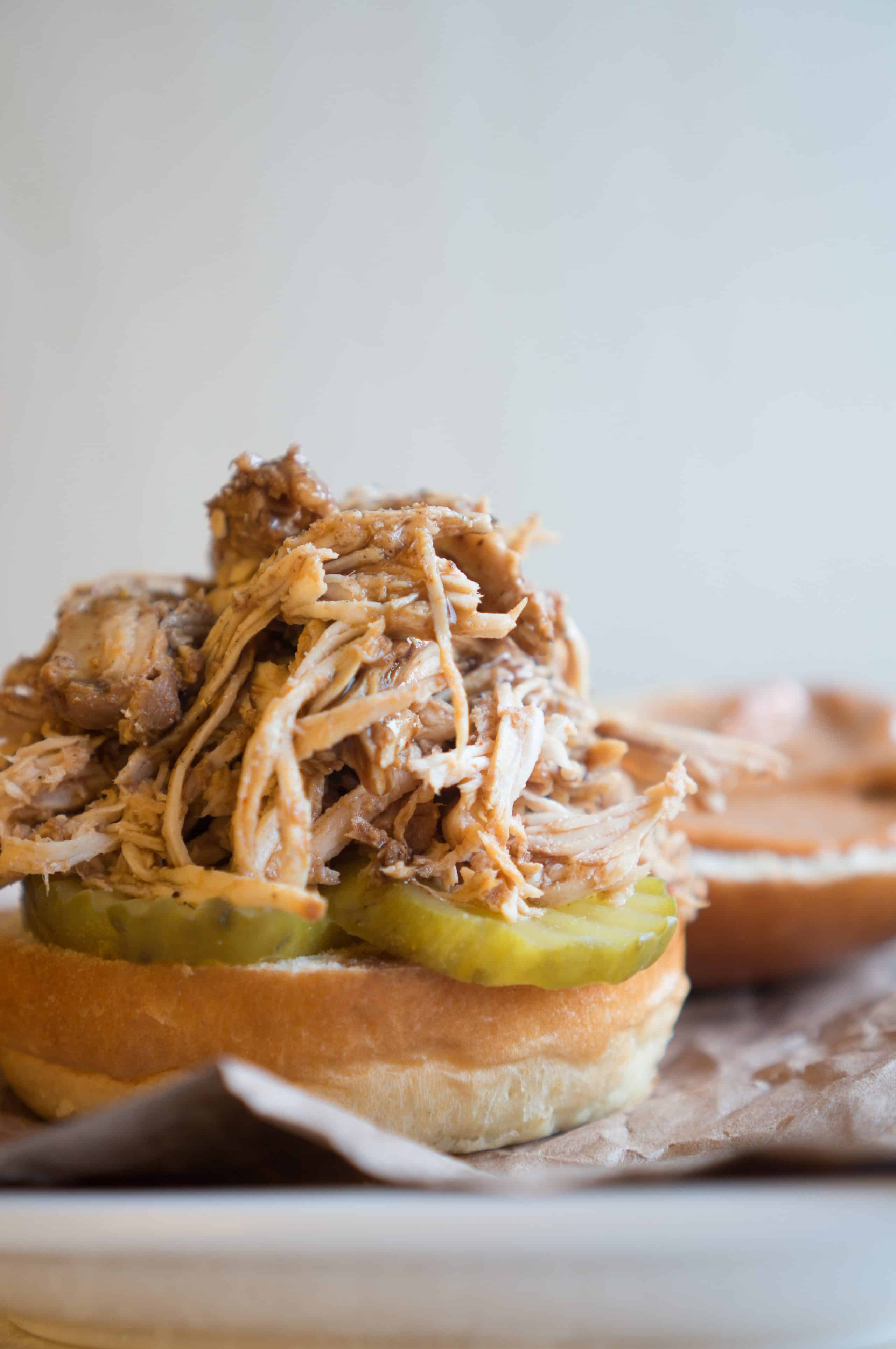 BBQ Pulled Chicken Sliders – Easy Crockpot Shredded Chicken makes this BBQ Pulled Chicken Slider recipe a cinch to pull off for weeknight dinners or weekend gatherings! Lean, protein-packed chicken + sweet BBQ sauce + smokey chipotle mayo + crunchy pickles all loaded up on a baby brioche bun. We love how easy these tasty little sliders are to assemble! They are a total life-saver for those parties where you have LOTS of mouths to feed but don’t want to get stuck in the kitchen all night! ♥ | freeyourfork.com