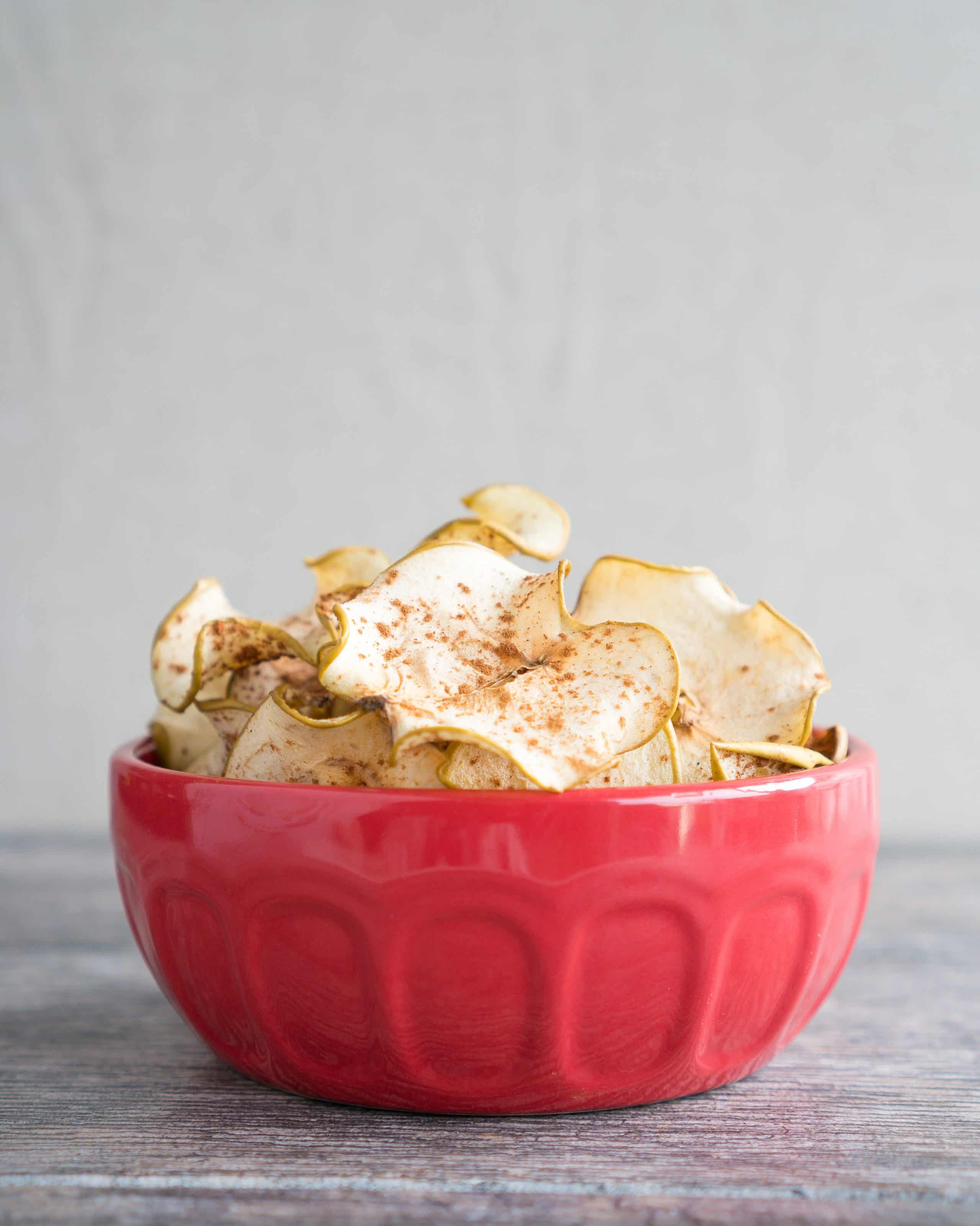 Cinnamon Spiced Apple Chips - Simple, 2-ingredient recipe for homemade Cinnamon Spiced Apple Chips. We love that this naturally sweet, healthy snack uses only whole apples and a sprinkle of cinnamon! Paleo-friendly, gluten-free, sugar-free & vegan ♥ | freeyourfork.com