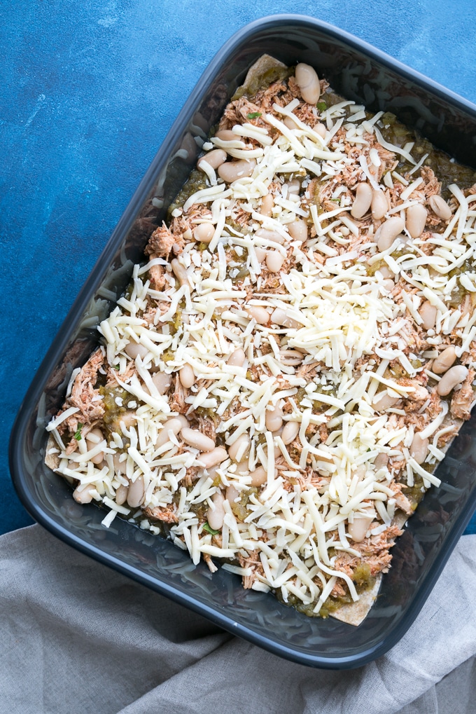 Green Chicken Enchilada Casserole - A healthy recipe for Green Chicken Enchilada Casserole! Baked in the oven with layers of soft tortillas, melty cheese, lean shredded chicken, white beans, salsa verde, and hatch chiles. Perfect for weekly meal-prep!! ♥ | freeyourfork.com