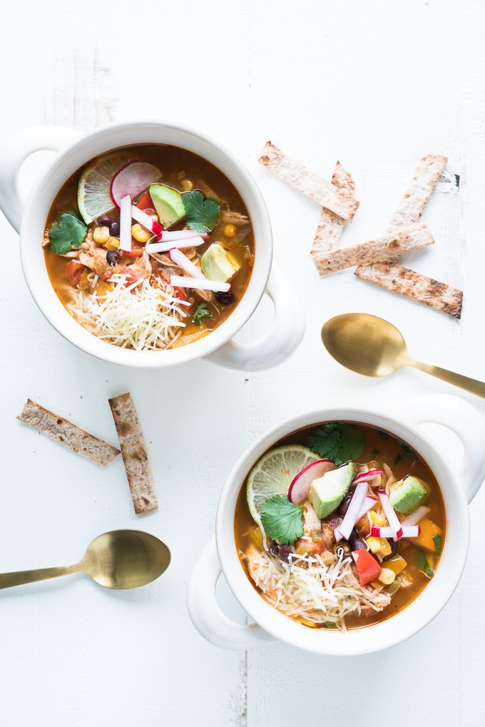 Chicken Tortilla Soup - Healthy recipe made in the instant pot using lean chicken breast, black beans, tomatoes, bell peppers, green chiles, jalapeño, corn, and more. Best served with toppings like sour cream + avocado + crisped tortilla strips! ♥ | freeyourfork.com