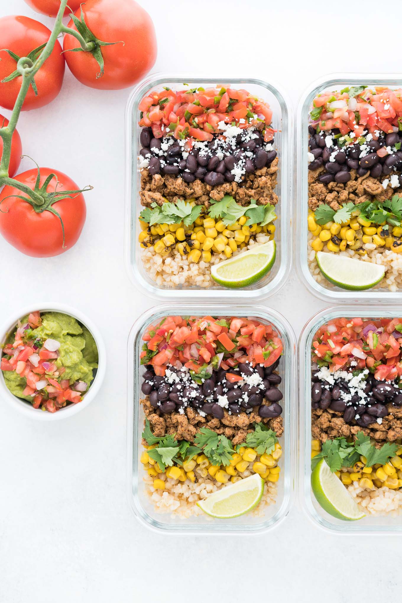 Meal Prep Burrito Bowls with Guacamole Dish and Tomatoes